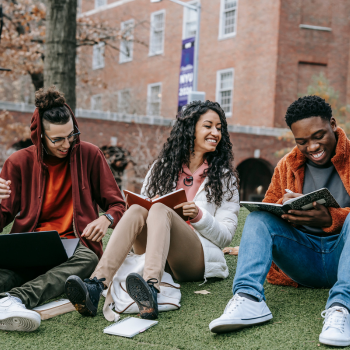 Three college students studying outside