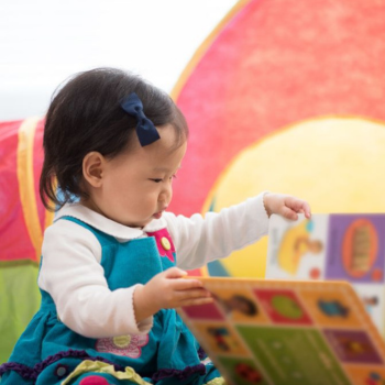 Child looking at board book