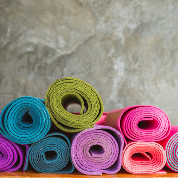 Colorful yoga mats rolled up.