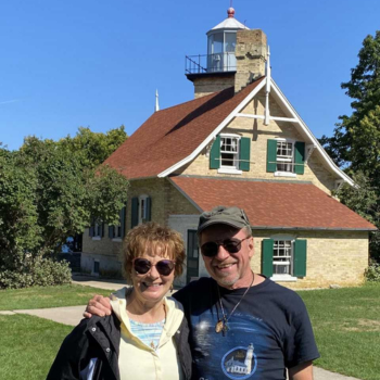 Barb and Ken Wardius in front of a lighthouse
