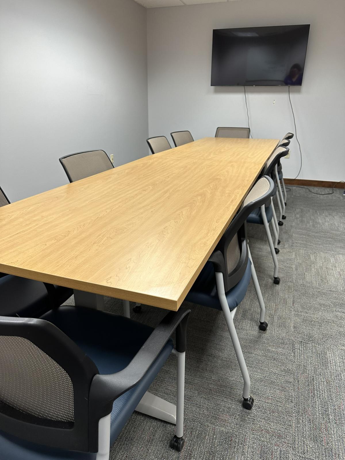 Conference room table setup for 12 with a TV