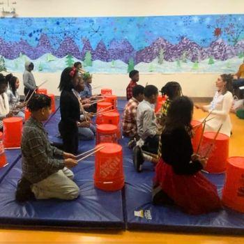 Children drumming on buckets